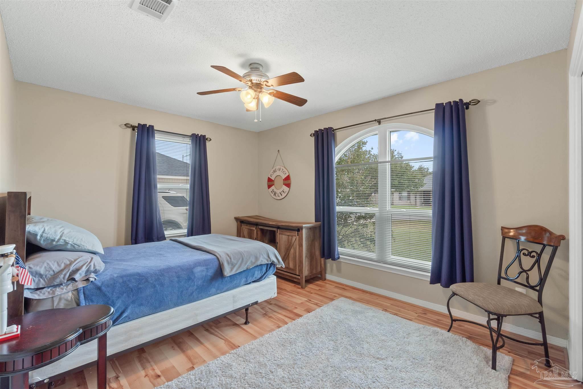 1342 Mazurek Boulevard Pensacola, FL 32514 - Photo 16 of 36 a bedroom with a large bed and a window
