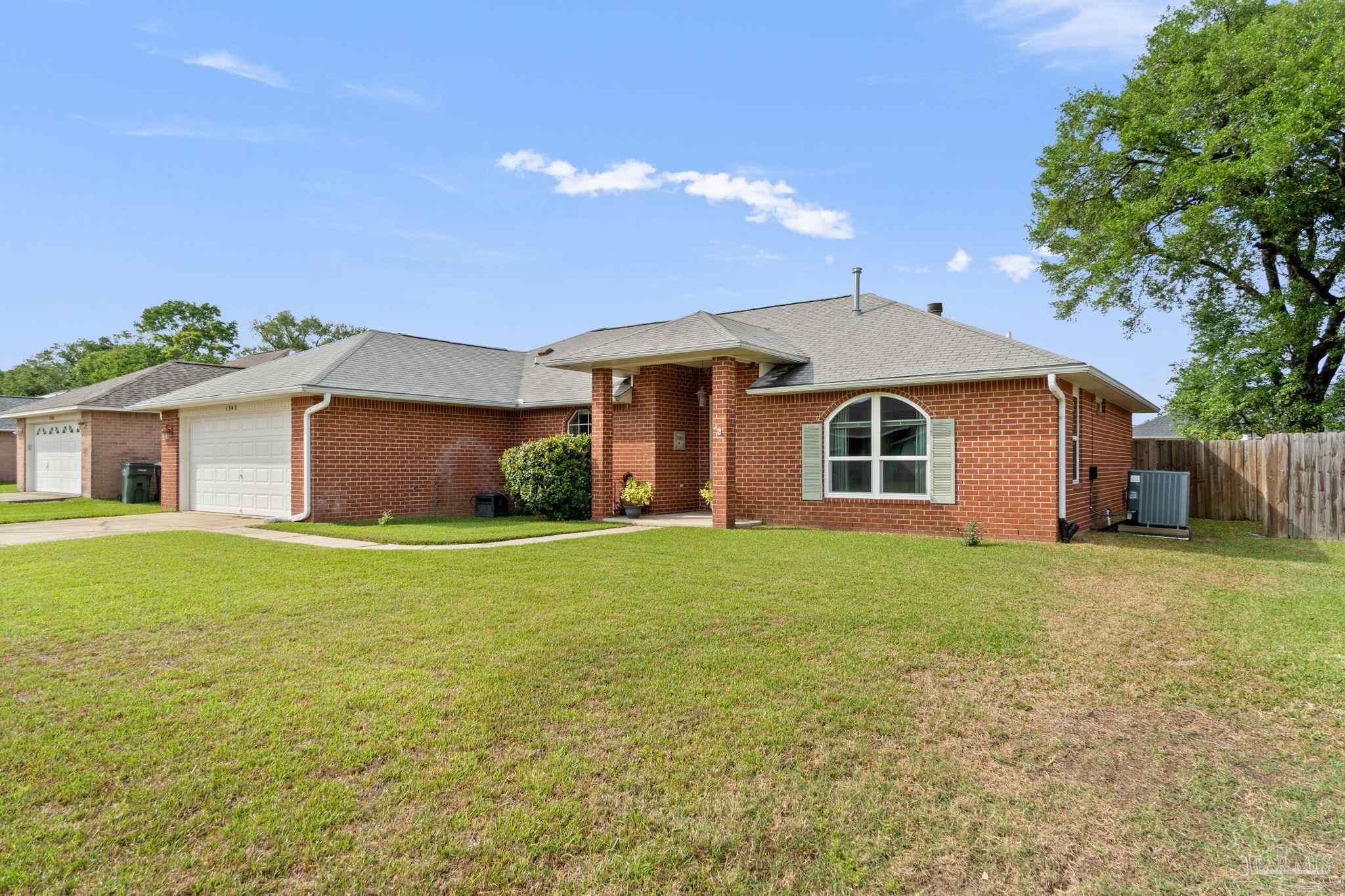 1342 Mazurek Boulevard Pensacola, FL 32514 - Photo 2 of 36 a front view of a house with a garden