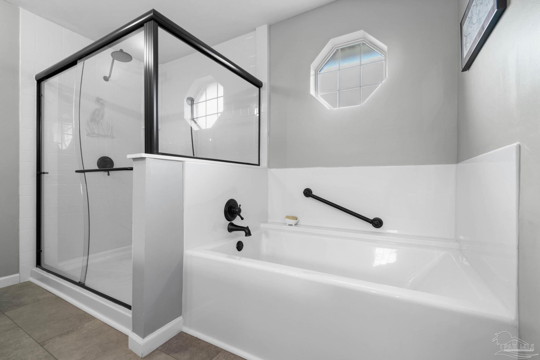 1342 Mazurek Boulevard Pensacola, FL 32514 - Photo 21 of 36 a bathroom with a bathtub and a shower