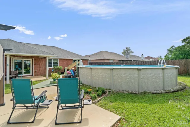 a view of a patio with a table chairs and a backyard
