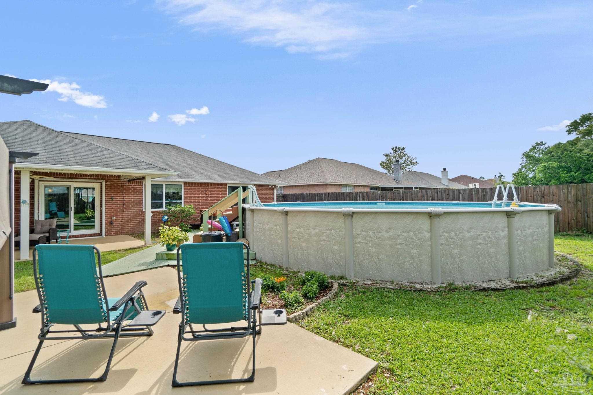 1342 Mazurek Boulevard Pensacola, FL 32514 - Photo 25 of 36 a view of a chairs and table in backyard of the house