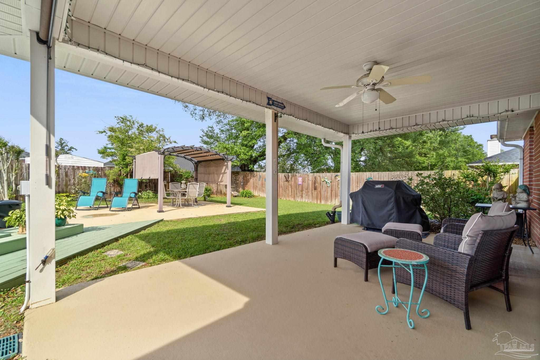 1342 Mazurek Boulevard Pensacola, FL 32514 - Photo 26 of 36 a view of a patio with a table chairs and a backyard
