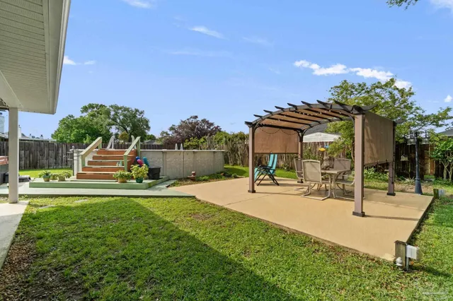a swimming pool with outdoor seating and yard