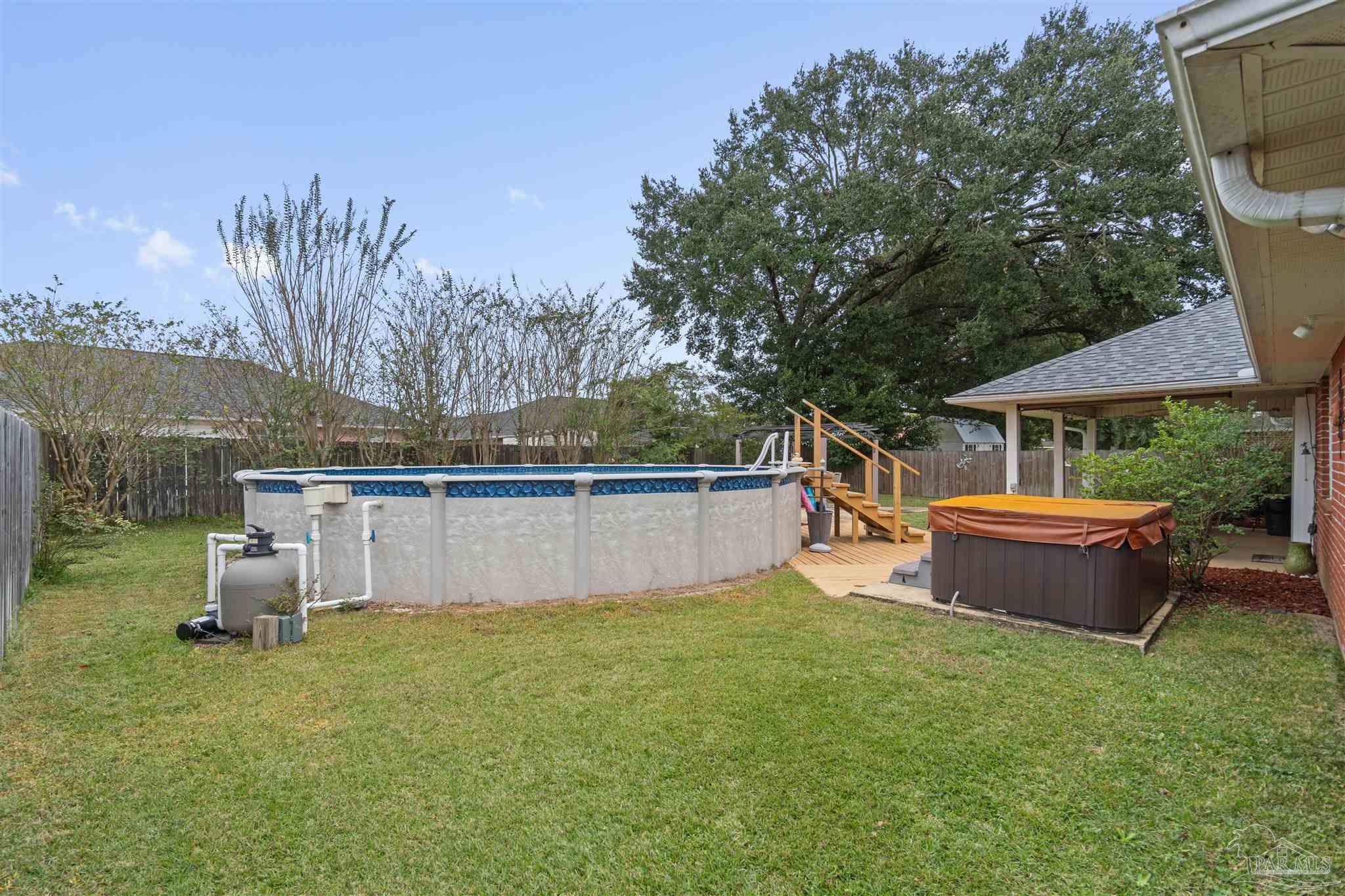 1342 Mazurek Boulevard Pensacola, FL 32514 - Photo 28 of 36 a swimming pool with outdoor seating and yard