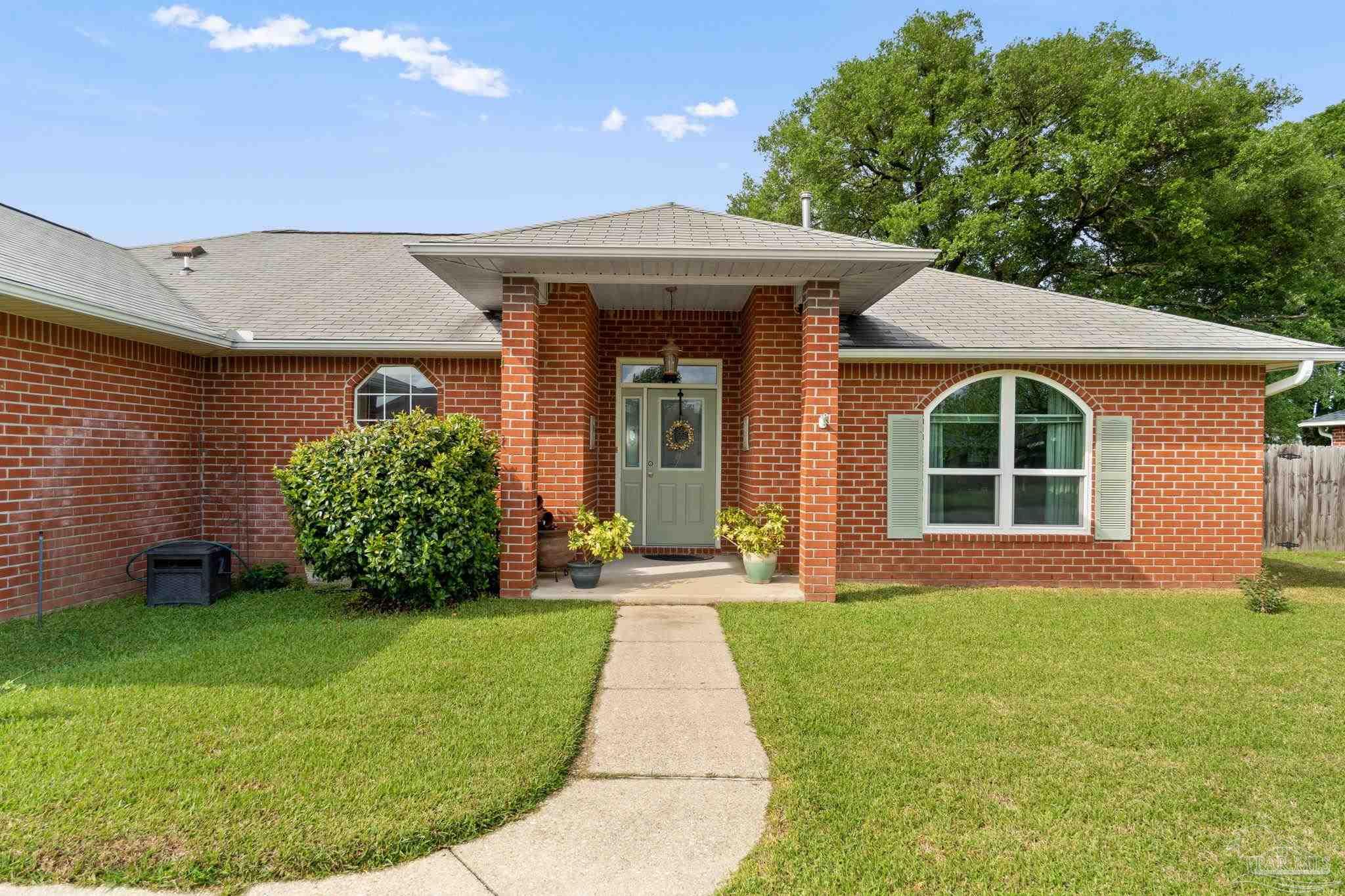 1342 Mazurek Boulevard Pensacola, FL 32514 - Photo 3 of 36 a front view of a house with a yard