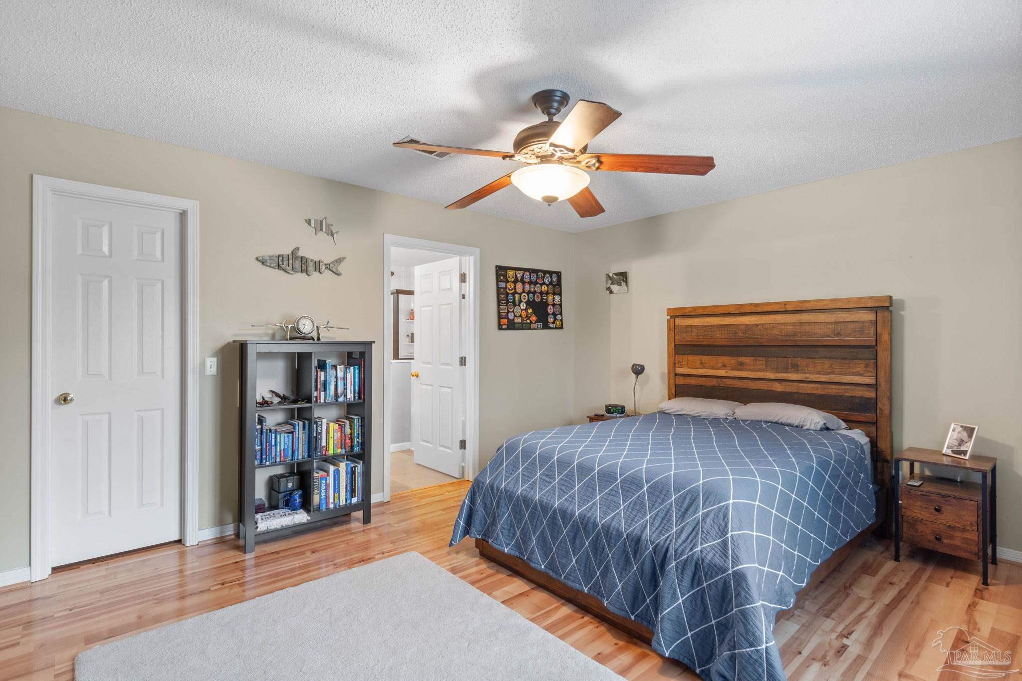 1342 Mazurek Boulevard Pensacola, FL 32514 - Photo 35 of 36 a bedroom with a bed and a chandelier