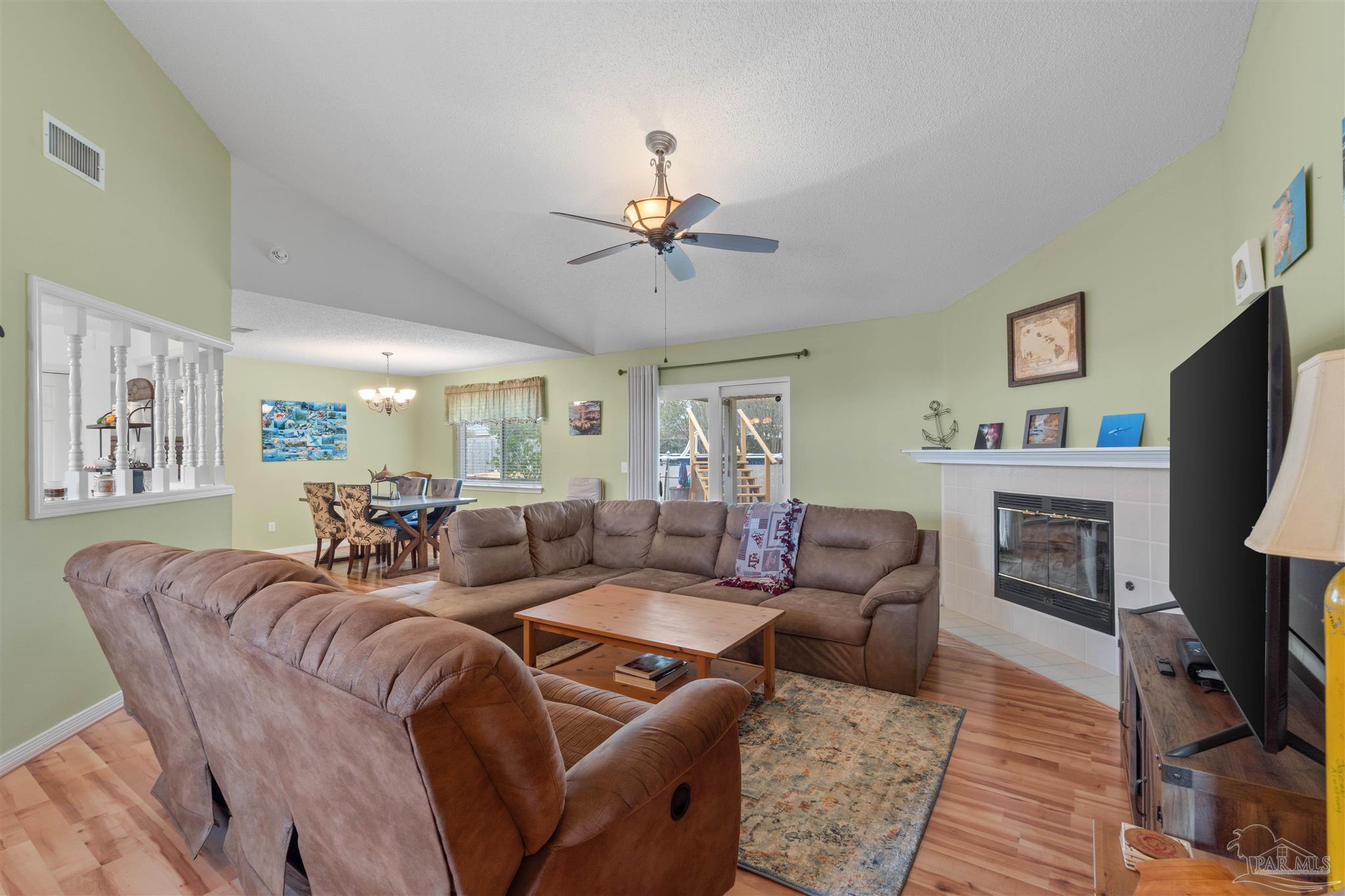 1342 Mazurek Boulevard Pensacola, FL 32514 - Photo 7 of 36 a living room with furniture a fireplace and a flat screen tv