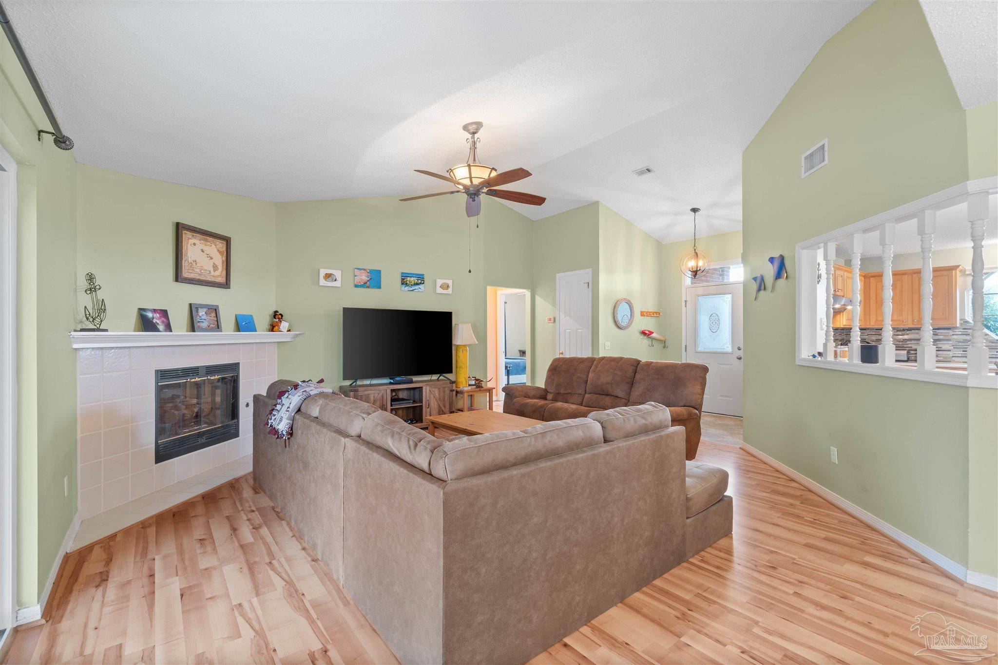 1342 Mazurek Boulevard Pensacola, FL 32514 - Photo 8 of 36 a living room with furniture a fireplace and a flat screen tv