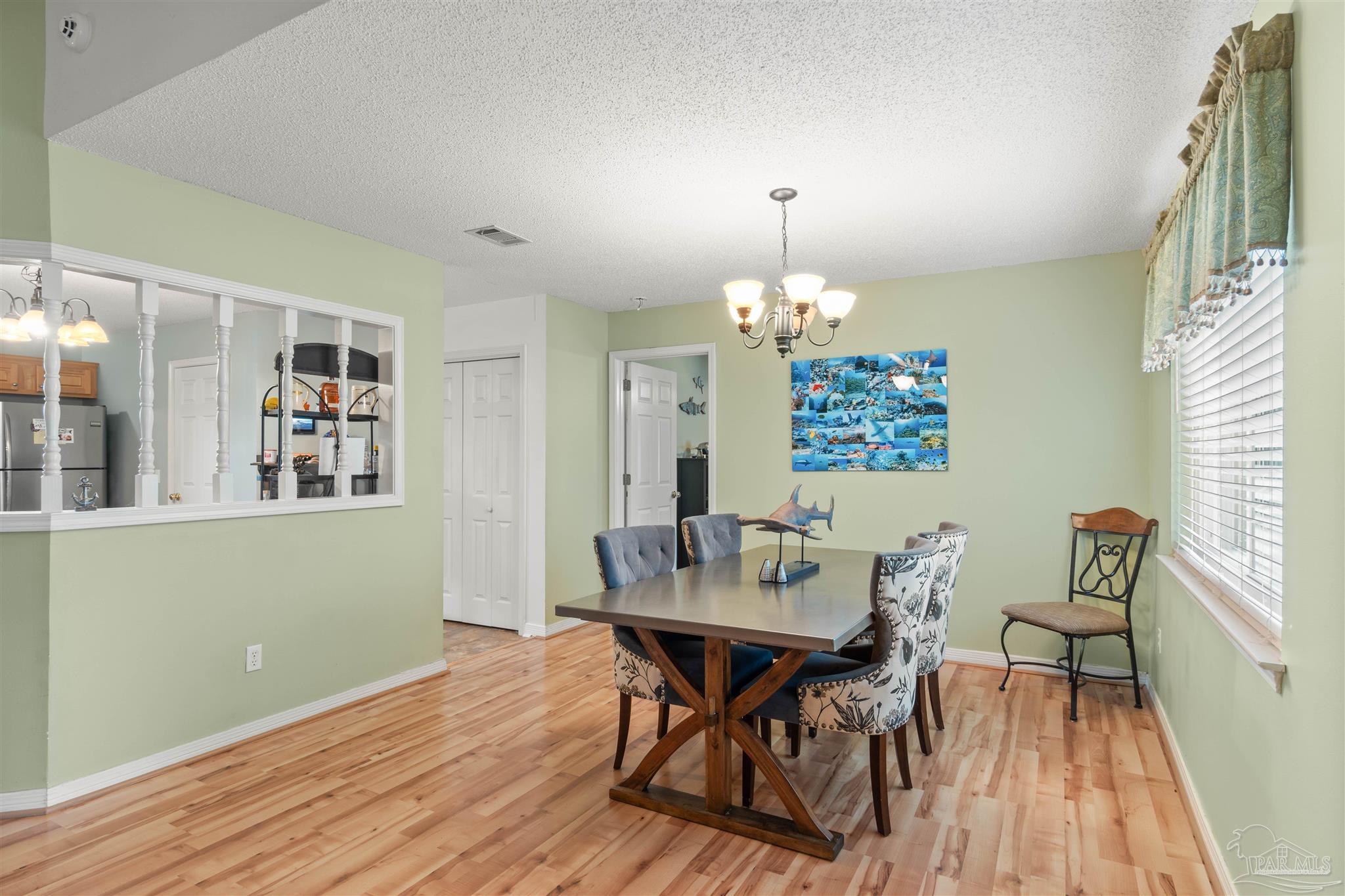 1342 Mazurek Boulevard Pensacola, FL 32514 - Photo 10 of 36 a view of a dining room with furniture window and wooden floor