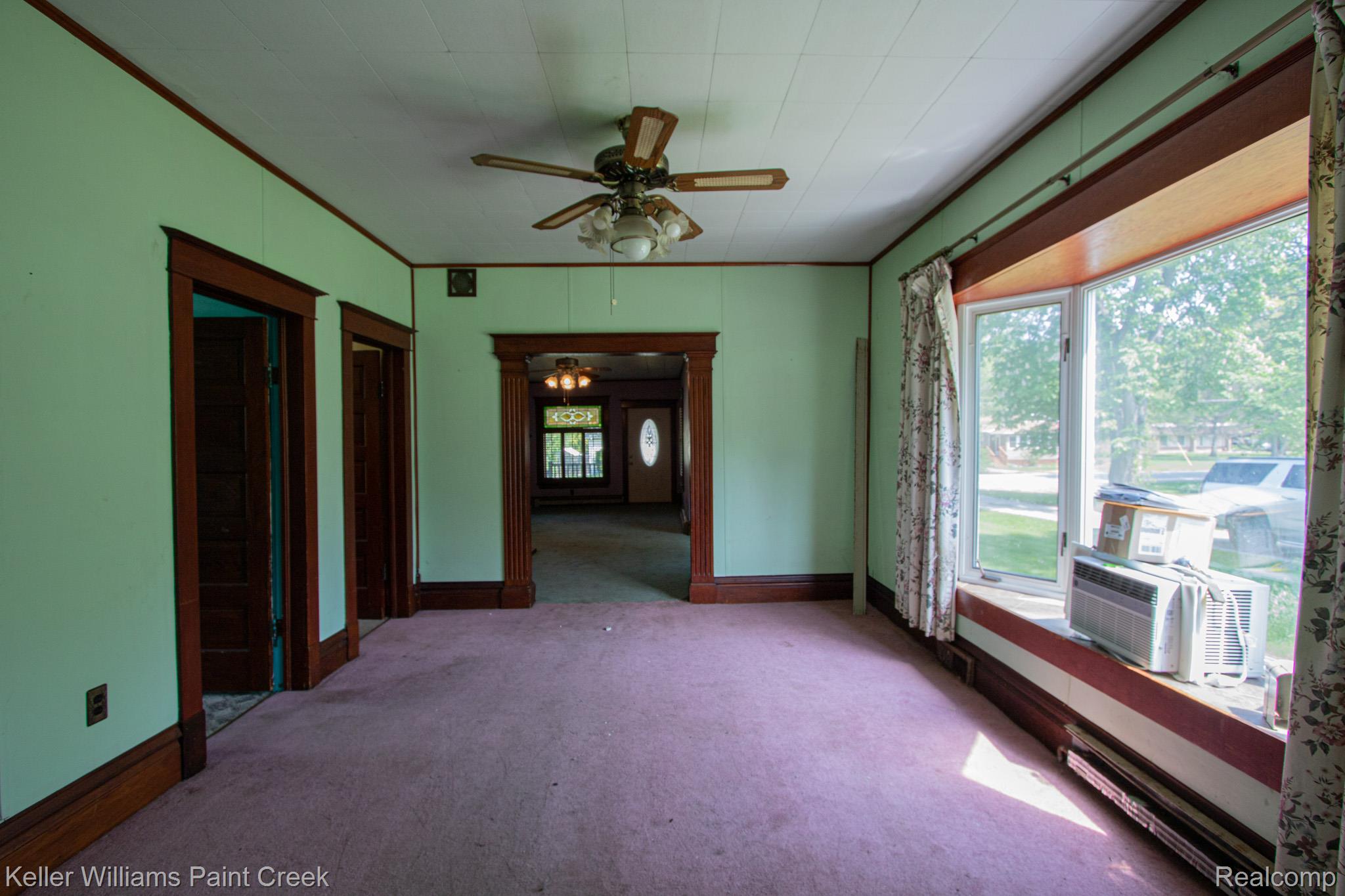 2165 Michigan Road Port Huron, MI 48060 - Photo 17 of 38 Carpeted empty room with ceiling fan and ornamental molding