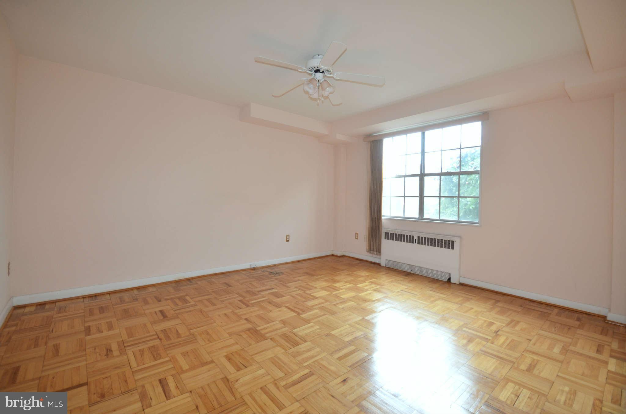 310 Ridgemede Road, Unit 206 Baltimore, MD 21210 - Photo 17 of 17 an empty room with a window and a ceiling fan