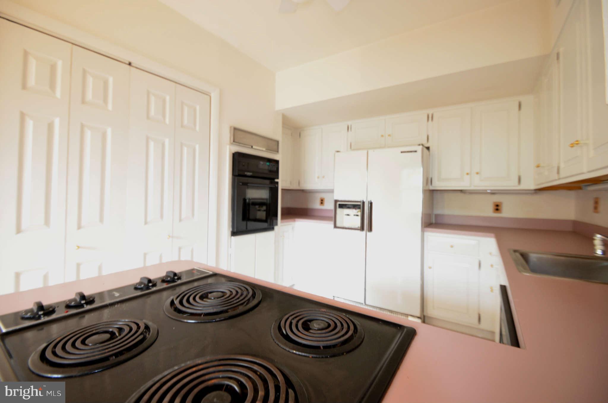310 Ridgemede Road, Unit 206 Baltimore, MD 21210 - Photo 10 of 17 a kitchen with a stove and a refrigerator