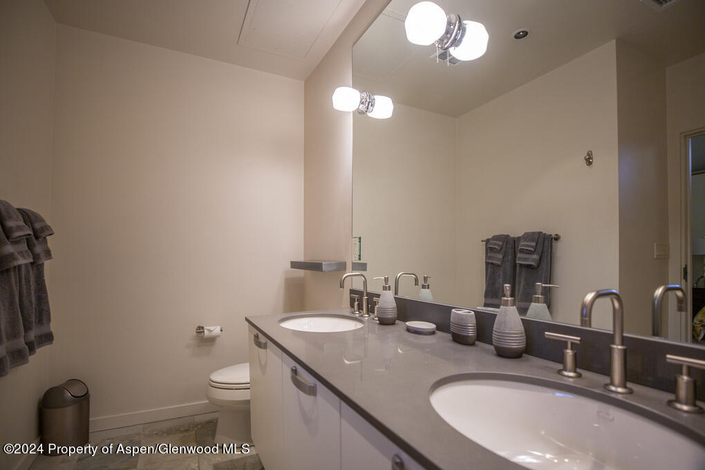 231 Robinson Street, Unit 330 Basalt, CO 81621 - Photo 18 of 45 a bathroom with a granite countertop sink a toilet and a mirror