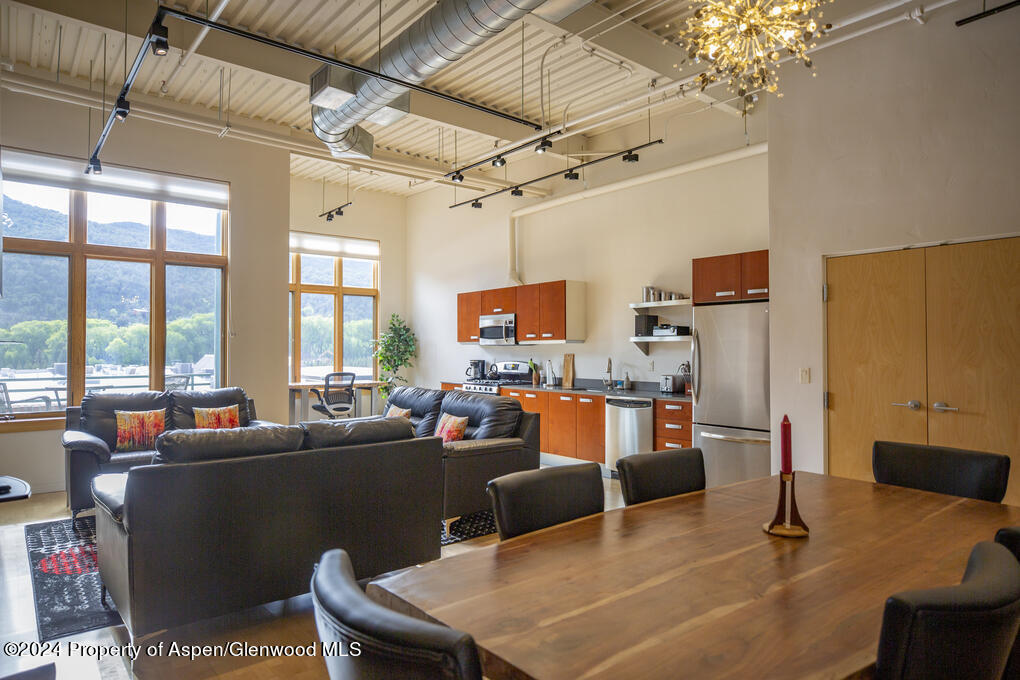 231 Robinson Street, Unit 330 Basalt, CO 81621 - Photo 2 of 45 a living room with furniture a flat screen tv and a chandelier