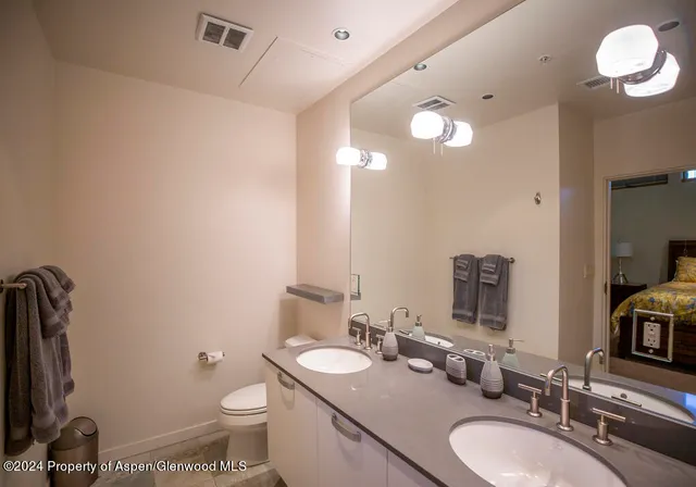 a bathroom with a double vanity sink and a mirror