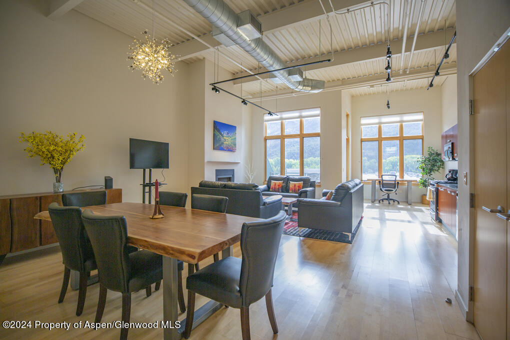 231 Robinson Street, Unit 330 Basalt, CO 81621 - Photo 3 of 45 a view of a dining room with furniture a chandelier and wooden floor