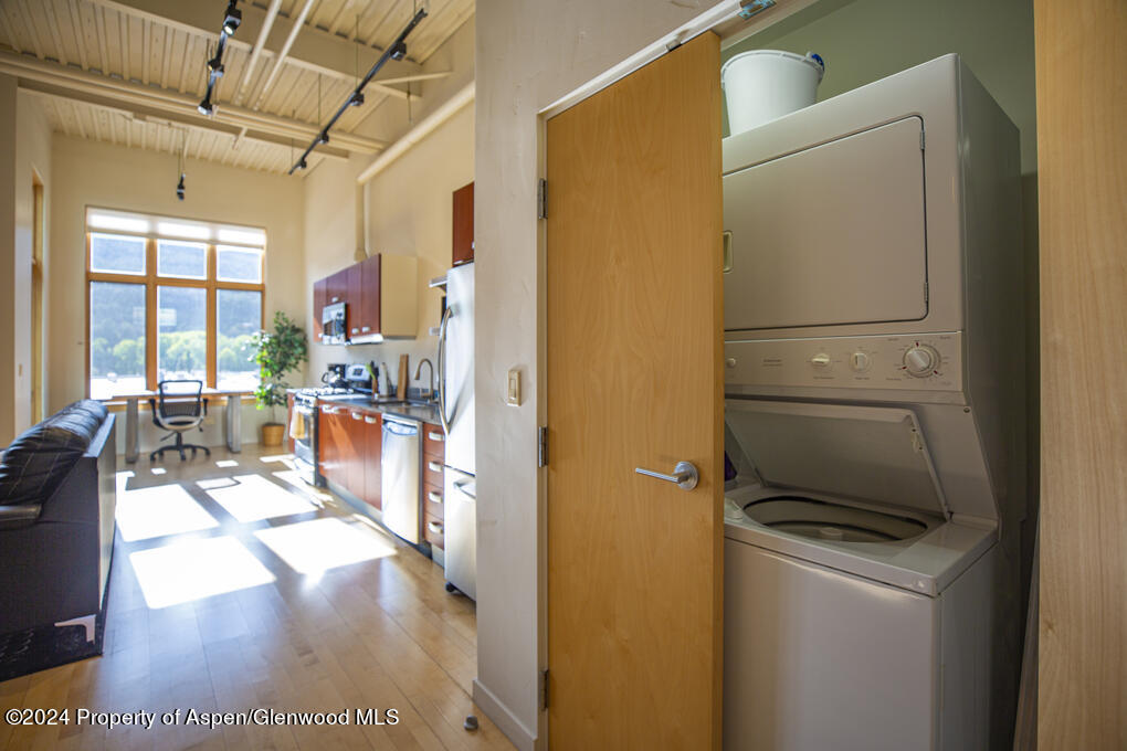 231 Robinson Street, Unit 330 Basalt, CO 81621 - Photo 31 of 45 a kitchen with stainless steel appliances a refrigerator a stove a sink a dining table and chairs with the view of kitchen