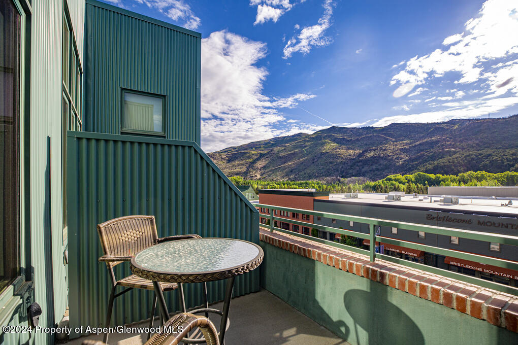 231 Robinson Street, Unit 330 Basalt, CO 81621 - Photo 36 of 45 a balcony with a table and chairs