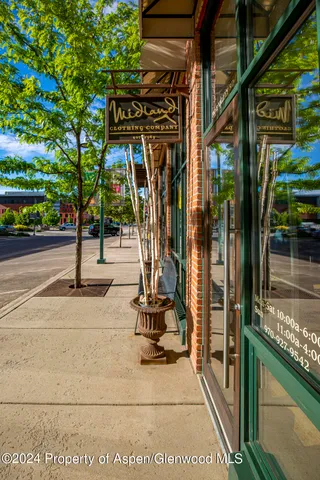 a city view with tall buildings and a yard