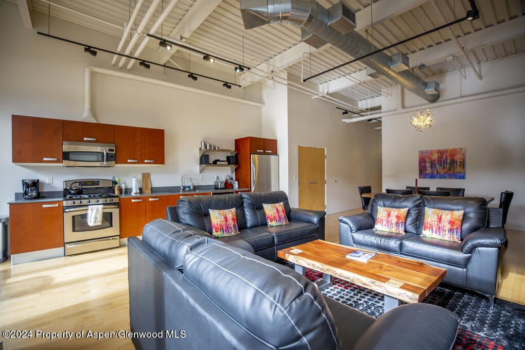 231 Robinson Street, Unit 330 Basalt, CO 81621 - Photo 5 of 45 a living room with furniture and a flat screen tv