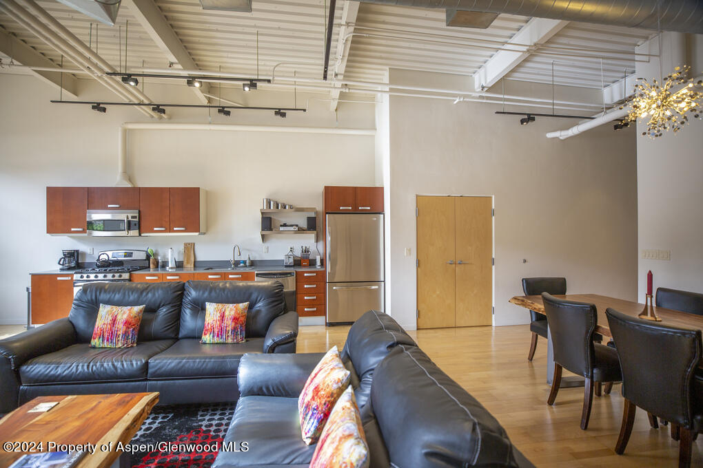 231 Robinson Street, Unit 330 Basalt, CO 81621 - Photo 8 of 45 a living room with furniture and a flat screen tv