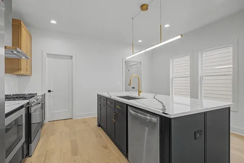a kitchen with a sink and stove