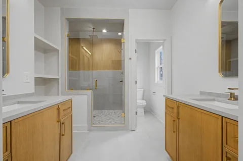 a bathroom with a granite countertop sink a mirror and a bathtub