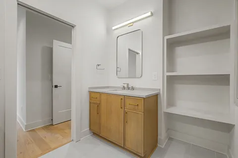 a bathroom with a sink a mirror and a vanity