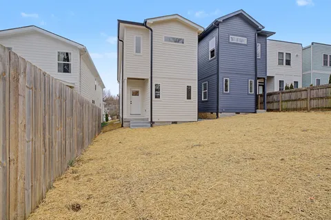 a view of a house with wooden fence