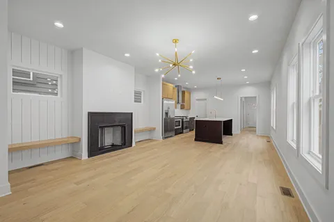 a view of a kitchen with a sink and a fireplace