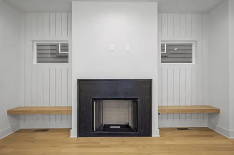 a room with a fireplace and a wooden floor