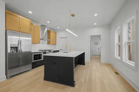 a kitchen with a sink stainless steel appliances and cabinets