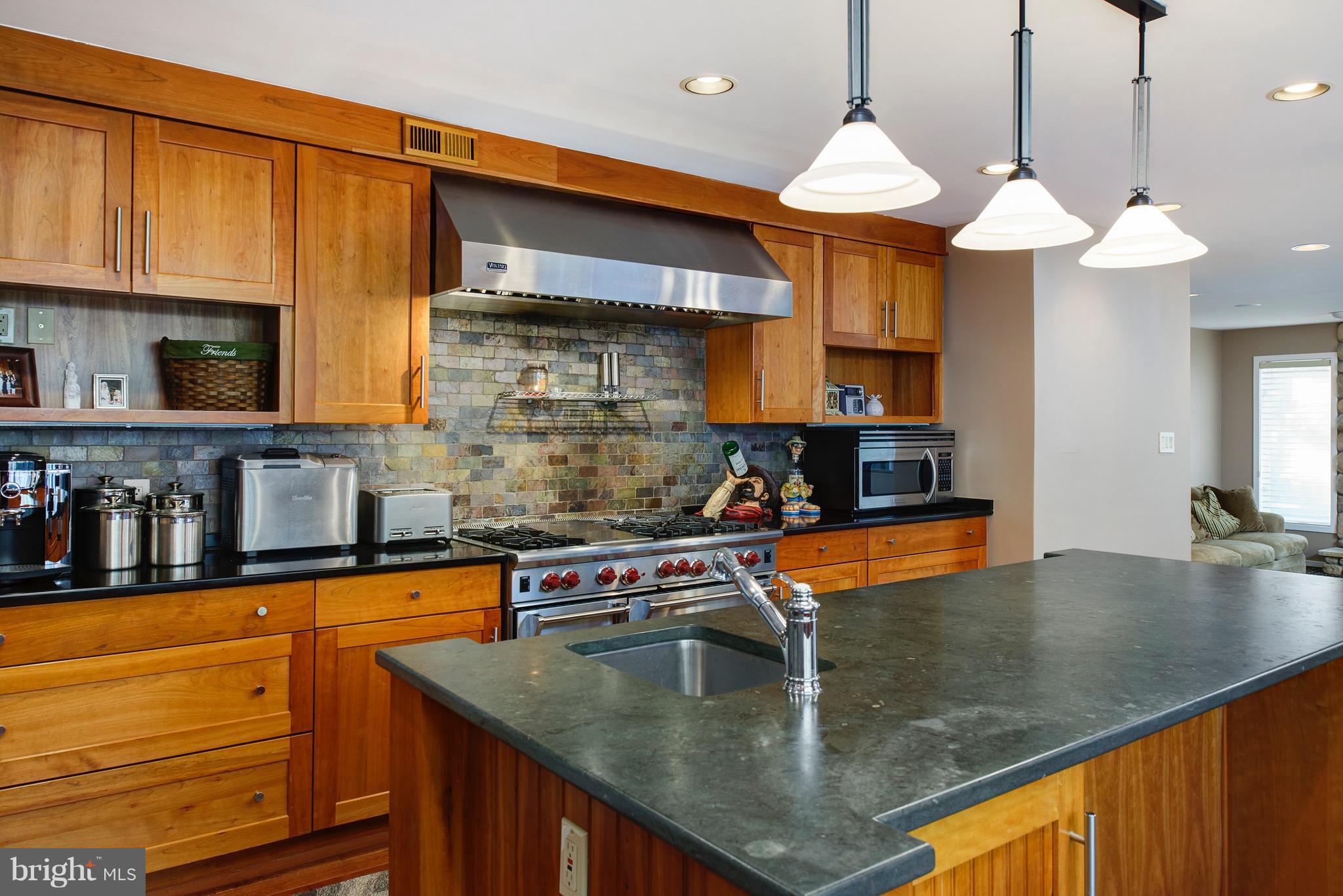 11400 Fieldstone Lane Reston, VA 20191 - Photo 8 of 28 a kitchen with stainless steel appliances granite countertop a sink a stove and a microwave