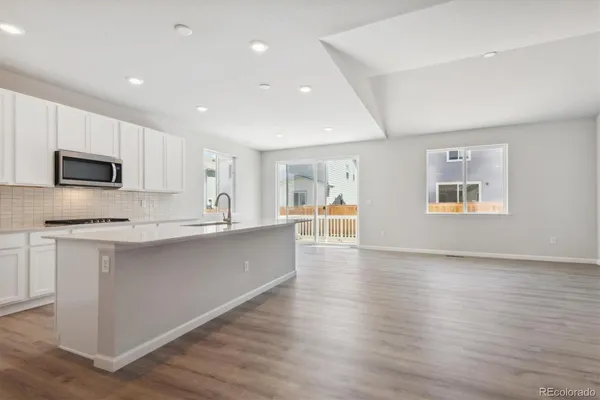 a kitchen with wooden cabinets and stainless steel appliances