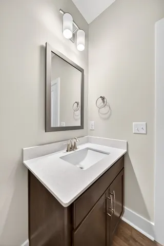 a kitchen with kitchen island a sink a stove a refrigerator and white cabinets