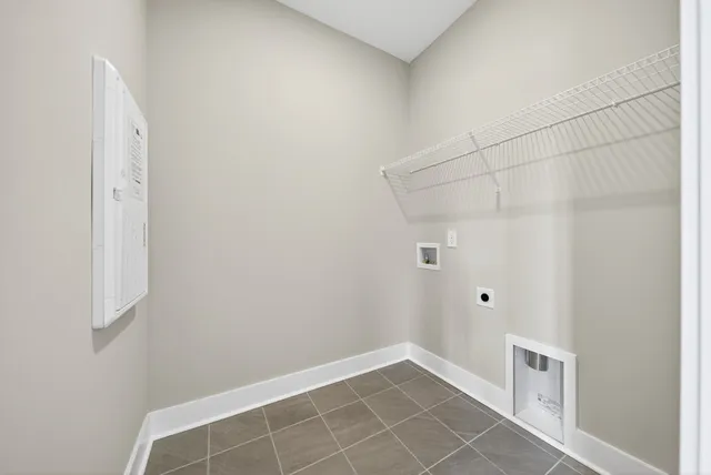 a kitchen with kitchen island granite countertop a sink white cabinets and stainless steel appliances