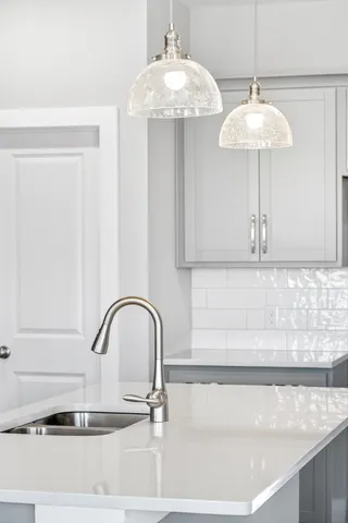 an empty room with windows and ceiling fan