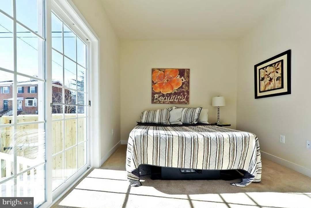 1406 22nd Street Southeast, Unit F Washington, DC 20020 - Photo 8 of 24 Bright and airy bedroom with outdoor access.