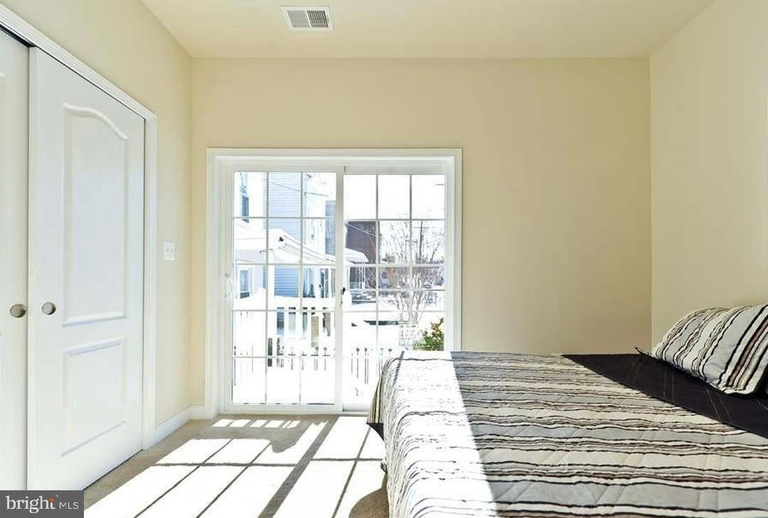 1406 22nd Street Southeast, Unit F Washington, DC 20020 - Photo 9 of 24 Bright and airy bedroom with serene views.