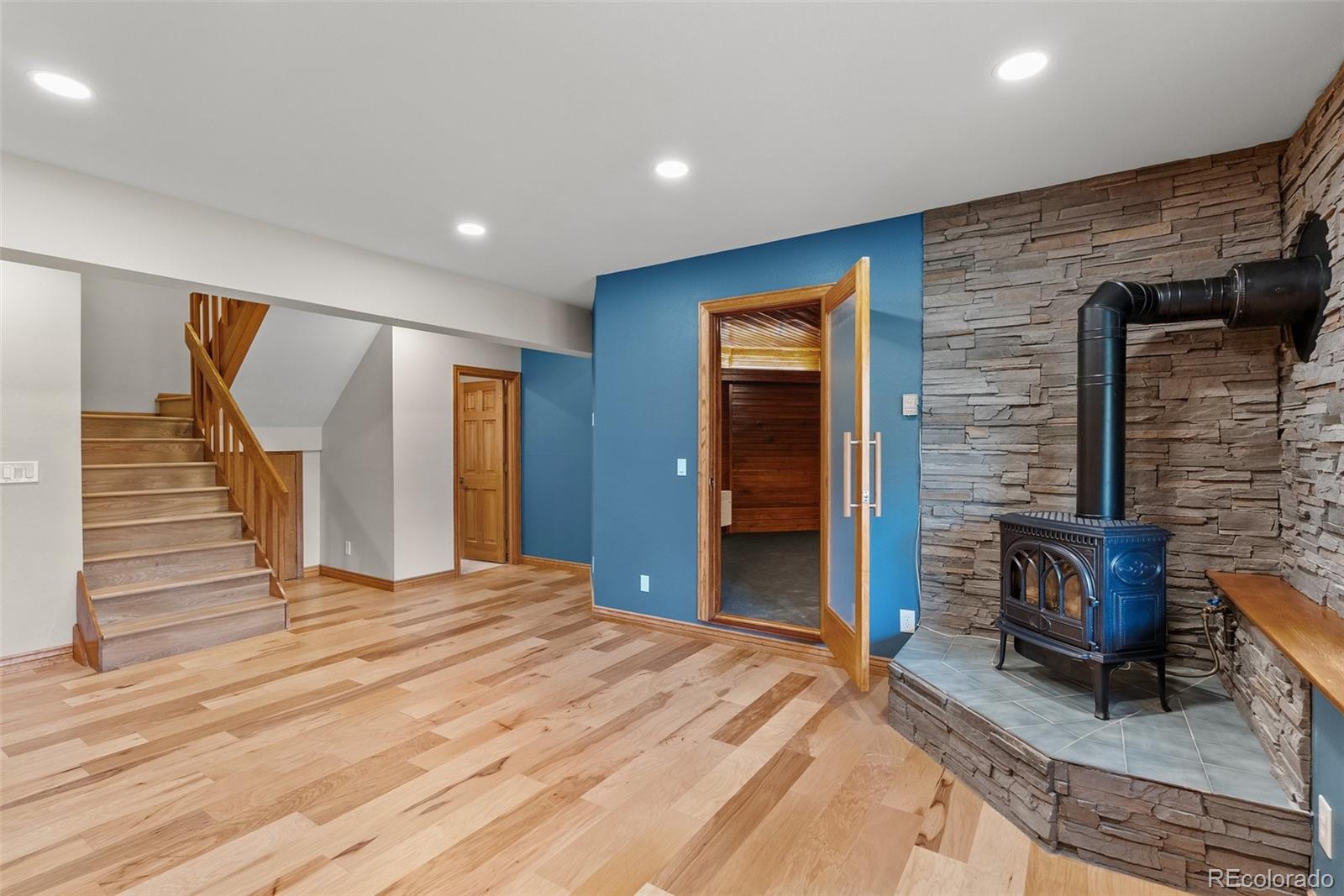 1403 Sinton Road Evergreen, CO 80439 - Photo 30 of 50 a view of a livingroom with wooden floor and chair