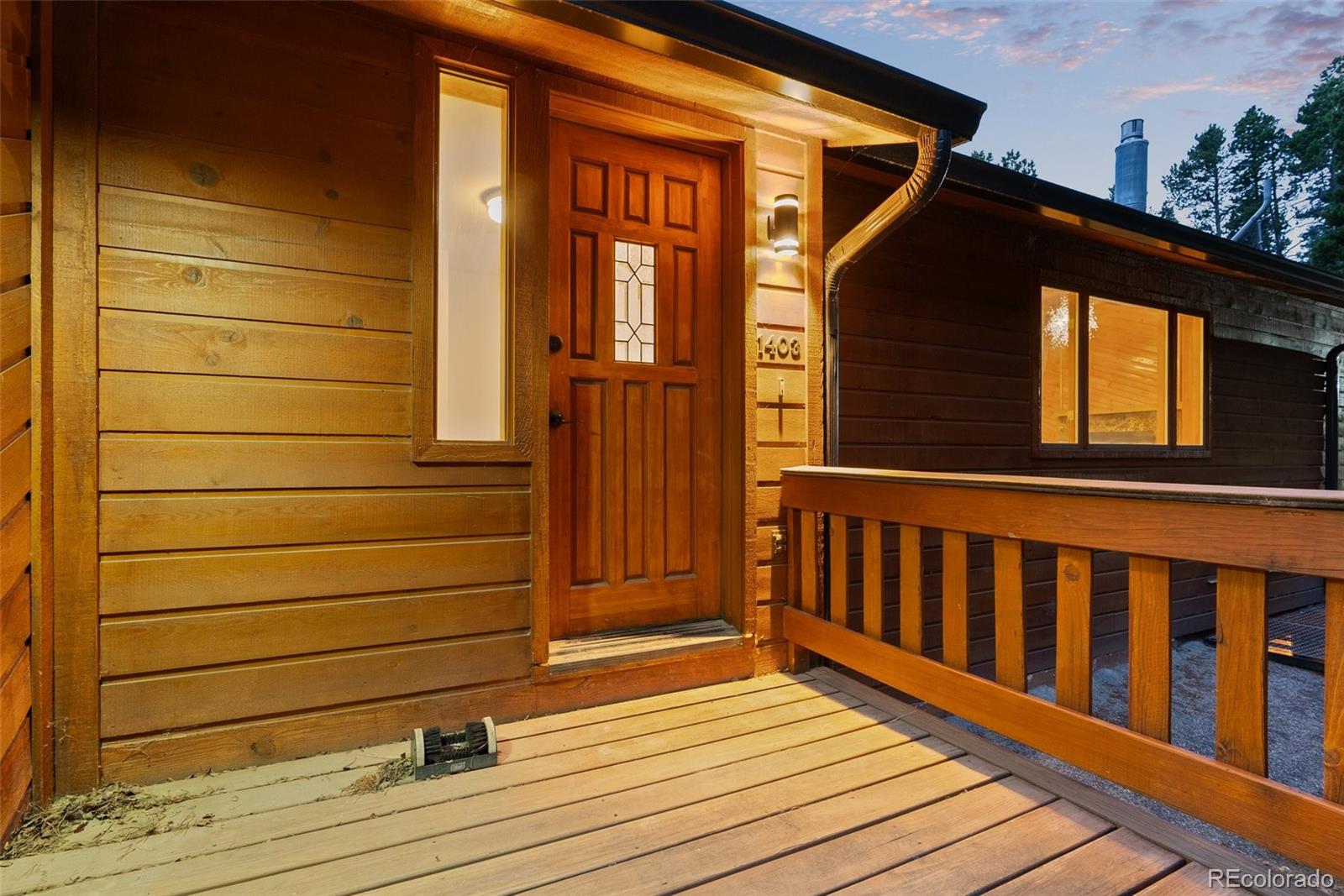 1403 Sinton Road Evergreen, CO 80439 - Photo 3 of 50 a view of a house with a wooden deck