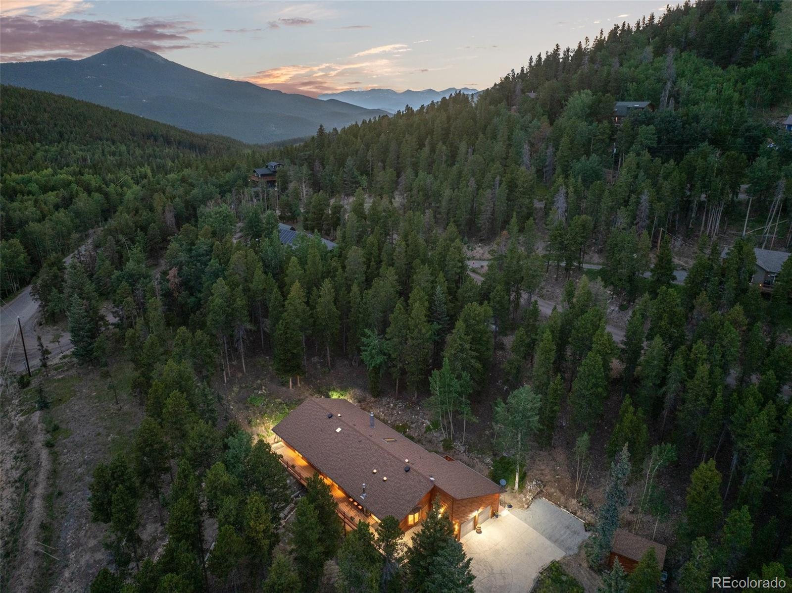 1403 Sinton Road Evergreen, CO 80439 - Photo 42 of 50 an aerial view of house with yard and mountain view