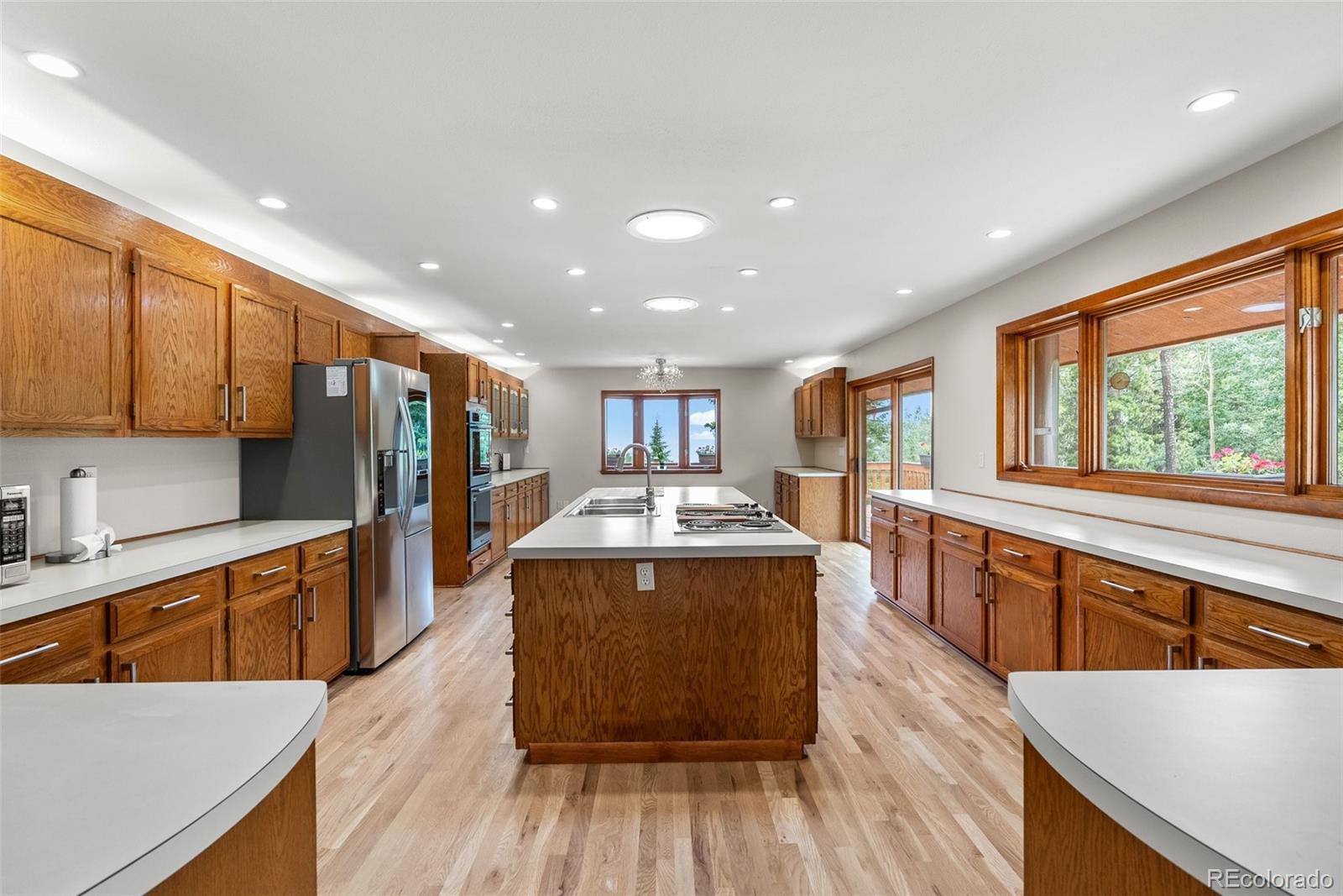1403 Sinton Road Evergreen, CO 80439 - Photo 5 of 50 a large kitchen with stainless steel appliances granite countertop a large center island and a sink