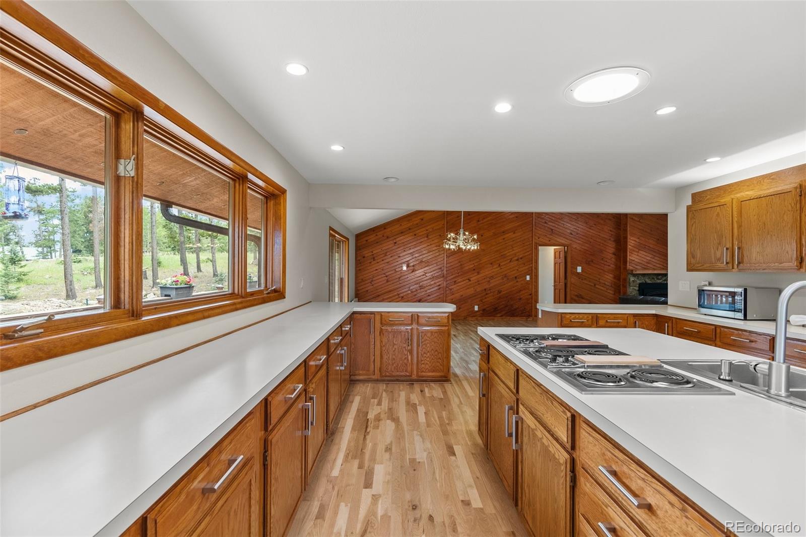 1403 Sinton Road Evergreen, CO 80439 - Photo 8 of 50 a kitchen with stainless steel appliances a stove top oven a sink and a refrigerator