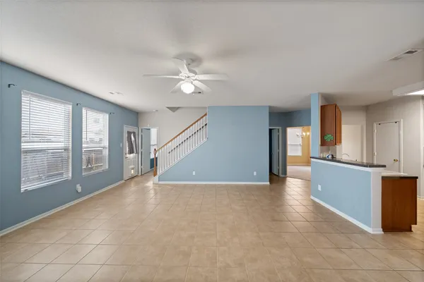 a view of an empty room with a fireplace and a window