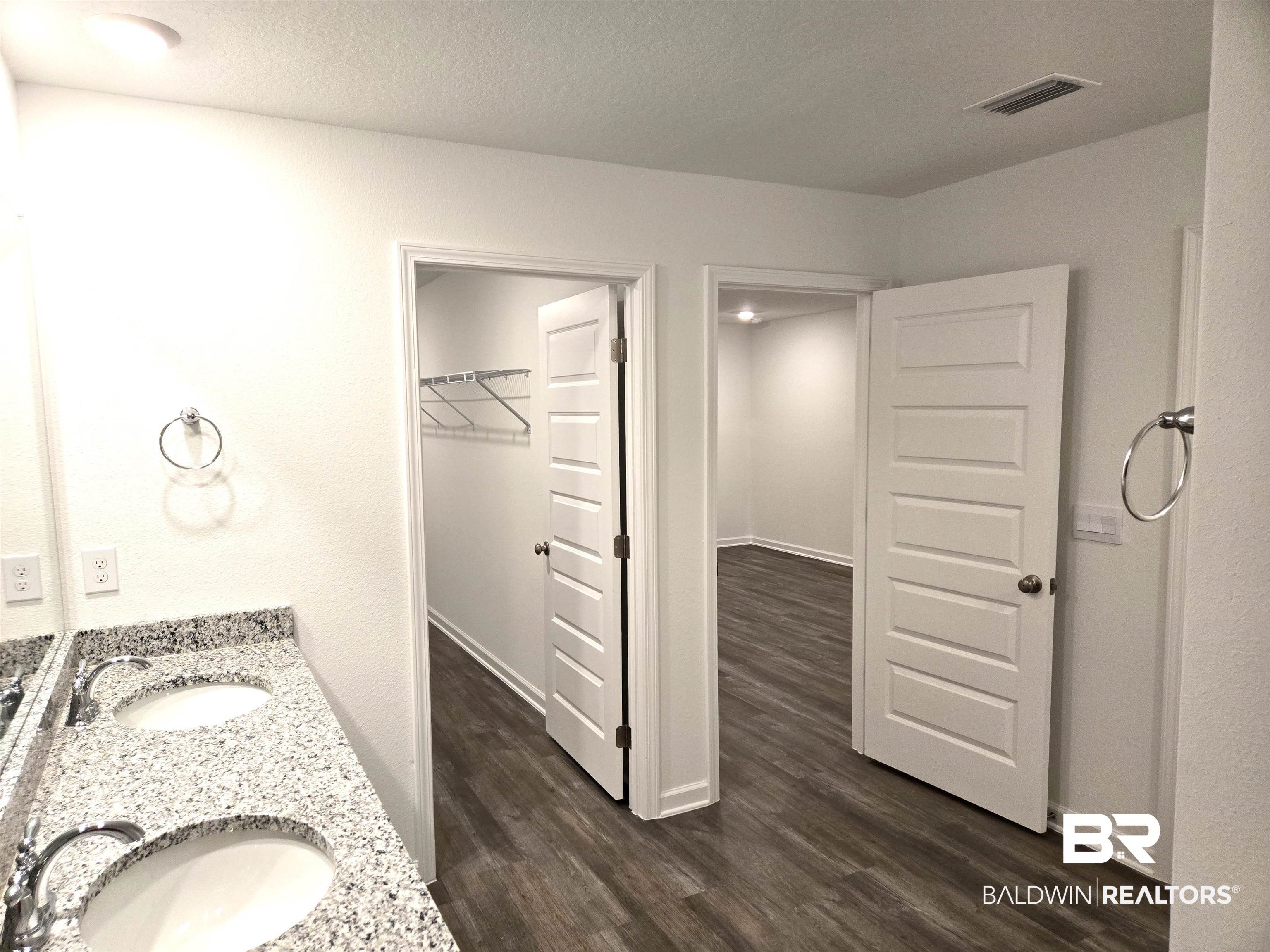 24321 Ringneck Loop Elberta, AL 36530 - Photo 32 of 39 Bathroom featuring vanity, wood-type flooring, and a textured ceiling