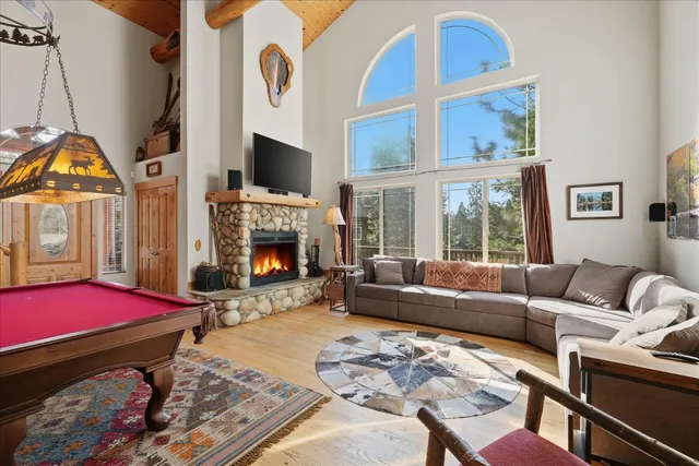 a view of a dining room with furniture a chandelier and wooden floor