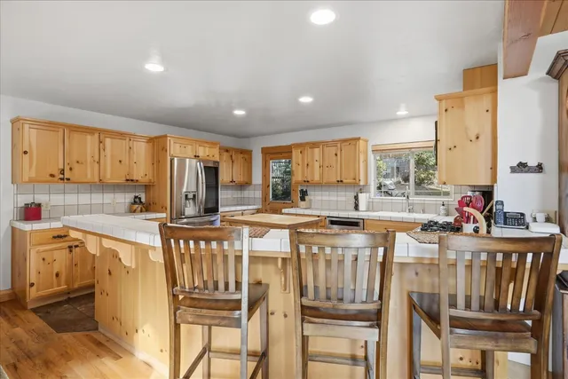 a kitchen with a sink a counter top space and stainless steel appliances