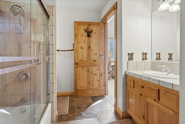a view of a balcony with wooden floor and fence