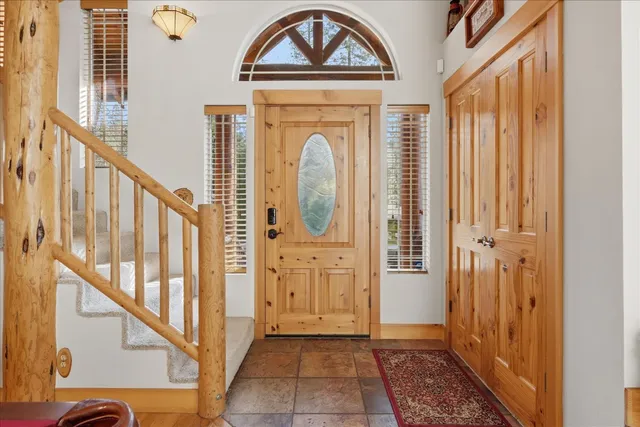 a room with pool table and windows